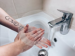 WomanÃÂ´s hands with inscription during washing photo